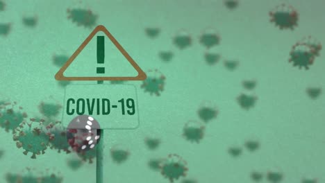 Animation-of-covid-19-cells-floating-and-warning-sign-over-dice-on-green-background