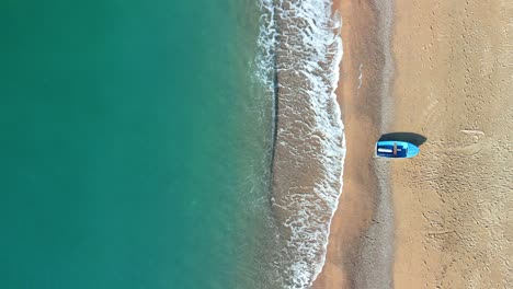 Overhead-Luftbild-Eines-Strandes-Mit-Einem-Statischen-Schuss-Eines-Kleinen-Fischerbootes