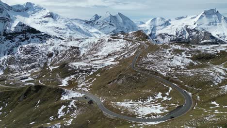 grossglockner high alpine road and snowy mountain peaks in austria alps - aerial 4k circling