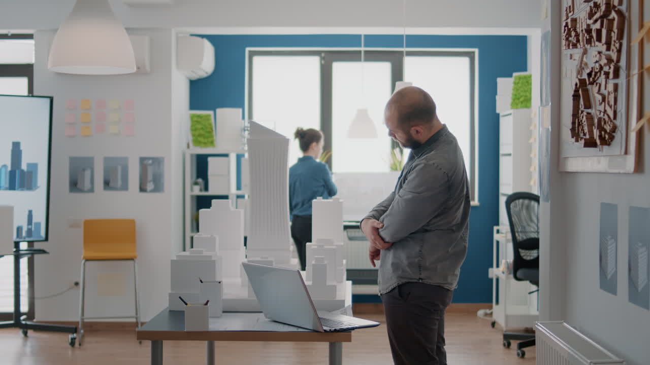 Architects reviewing building models in the office