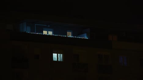 apartment balcony with faint festive lights glowing in the zagreb night