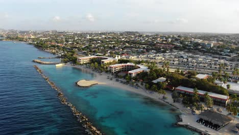 Mambo-Beach-resorts-at-Caribbean-island-Curaçao,-wide-aerial-parallax