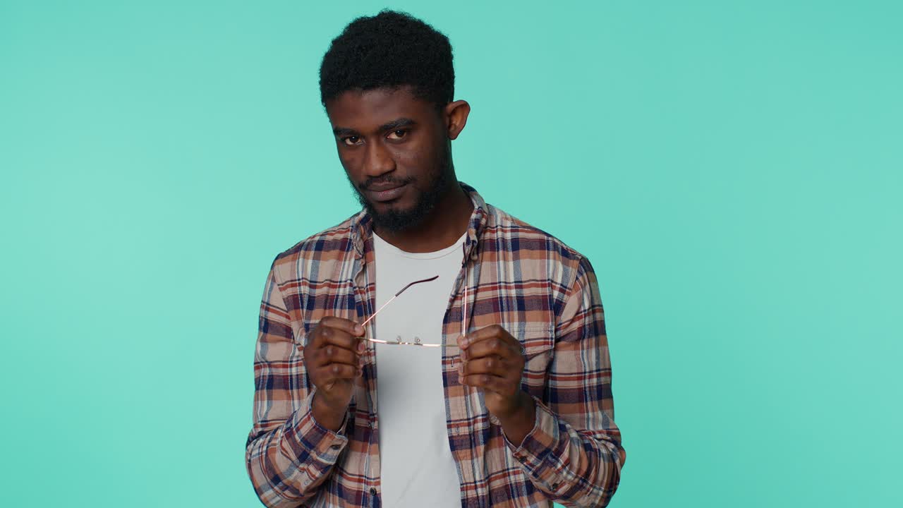 Playful happy man wearing sunglasses blinking eye looking at camera with smile, winking, flirting