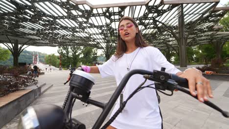 young woman on electric bike in park