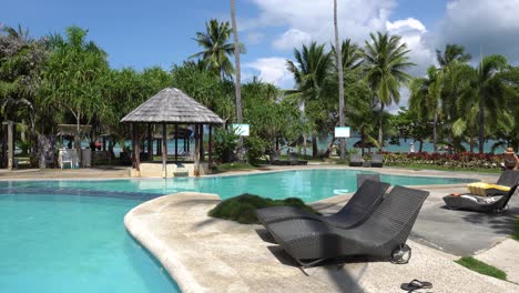 sun loungers by the pool side in dos palmas island resort, palawan