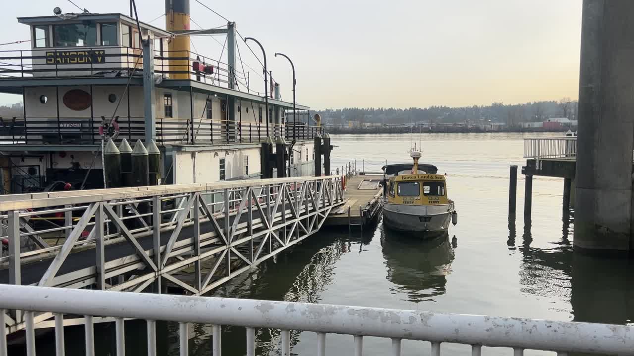 A picturesque river port with sailboats and yachts docked along the tranquil waterfront,