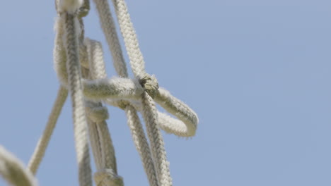 broken net rope against blue sky. close up