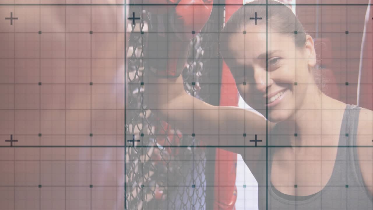Female athlete resting on gym cage, lifting head to camera, smiling as grid highlighting recovery