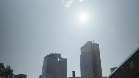 as a cloud relinquishes its hold over the sun, two residential towers in greenpoint, brooklyn, bask in the returned radiance