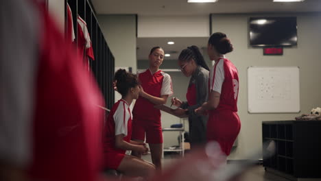 women's soccer team strategy session in locker room