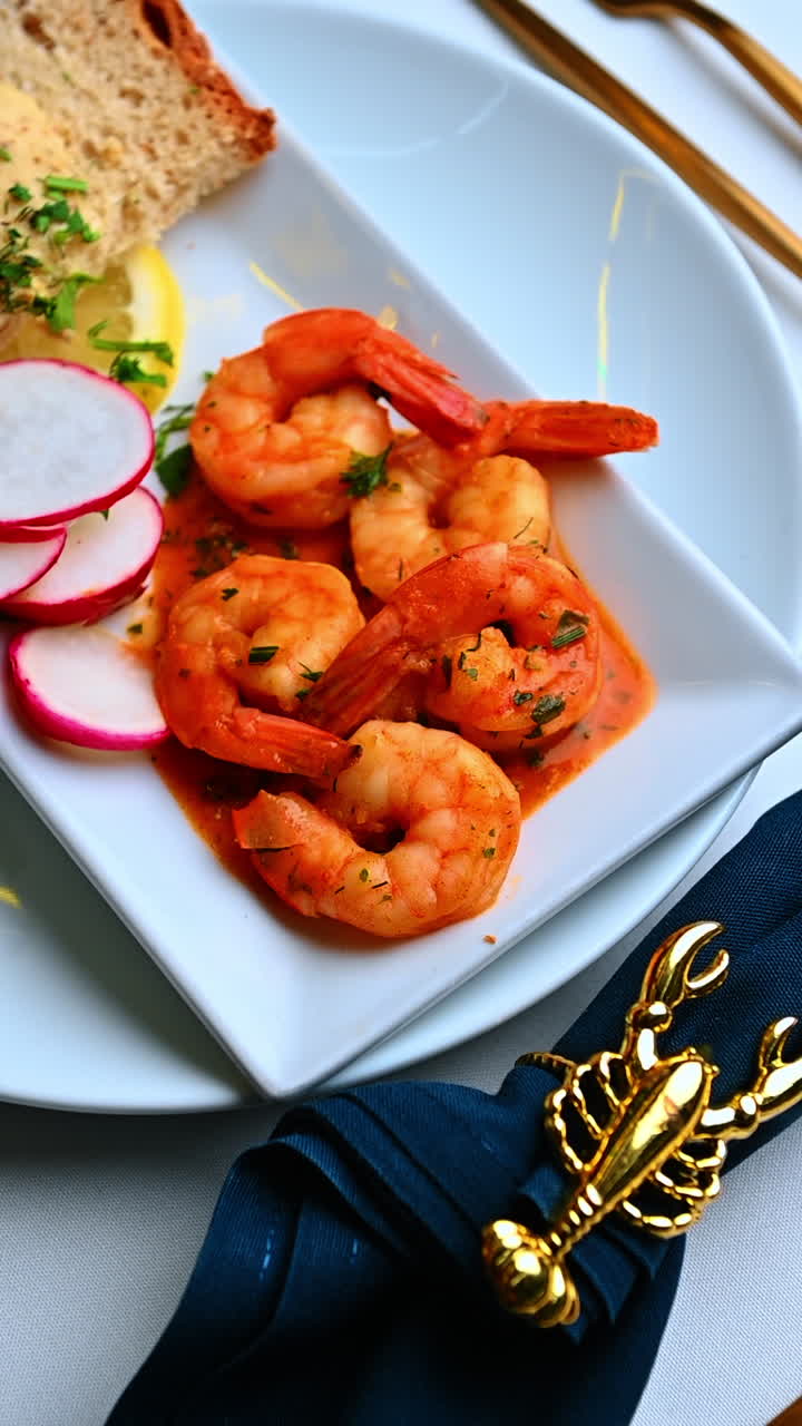 Shrimp dish with bread and herbs. Shrimp served with bread slice and herbs on clean table setting