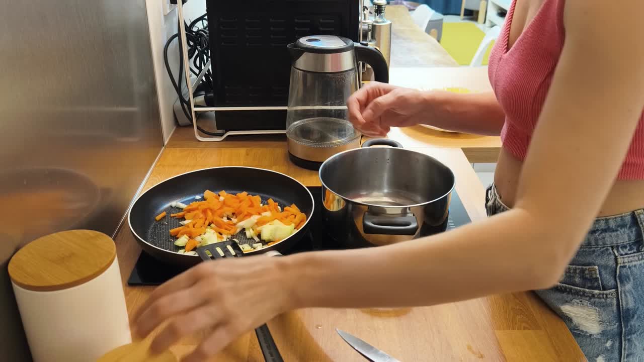 Woman cooking vegetables in the kitchen