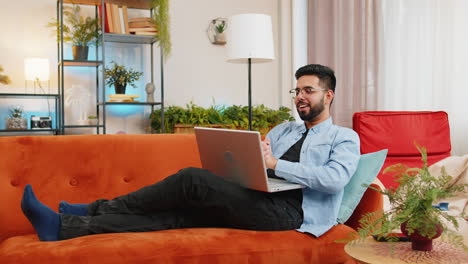 Happy-Indian-man-using-laptop-receive-good-news-shocked-by-victory-celebrate-lottery-jackpot-win