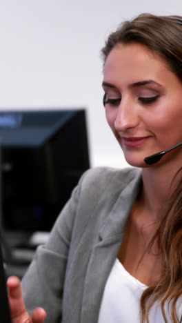 smiling call centre agent talking on the headset