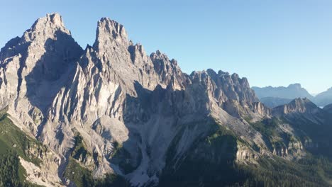 Close-up-aerial-view-of-high-mountain-peak-in-morning-sun