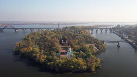 autumnal river island with bridges and churches