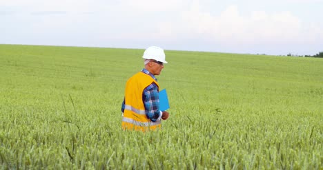 Engineer-Analyzing-Checklist-On-Clipboard-Amidst-Crops-At-Farm-2