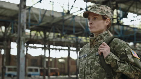 woman soldier in a damaged factory