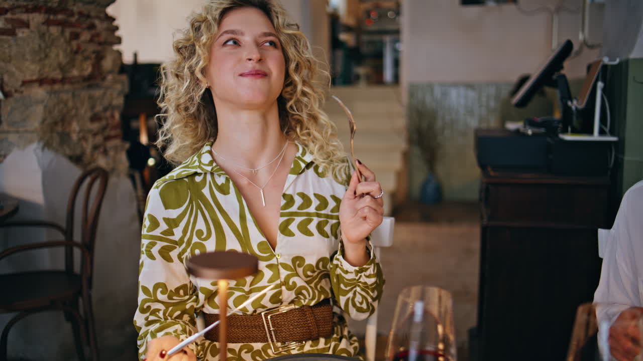 Smiling woman eating friends spending evening in modern restaurant closeup