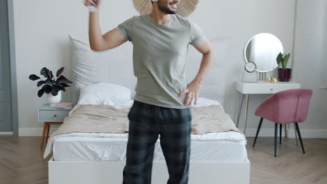 man relaxing and dancing in his bedroom
