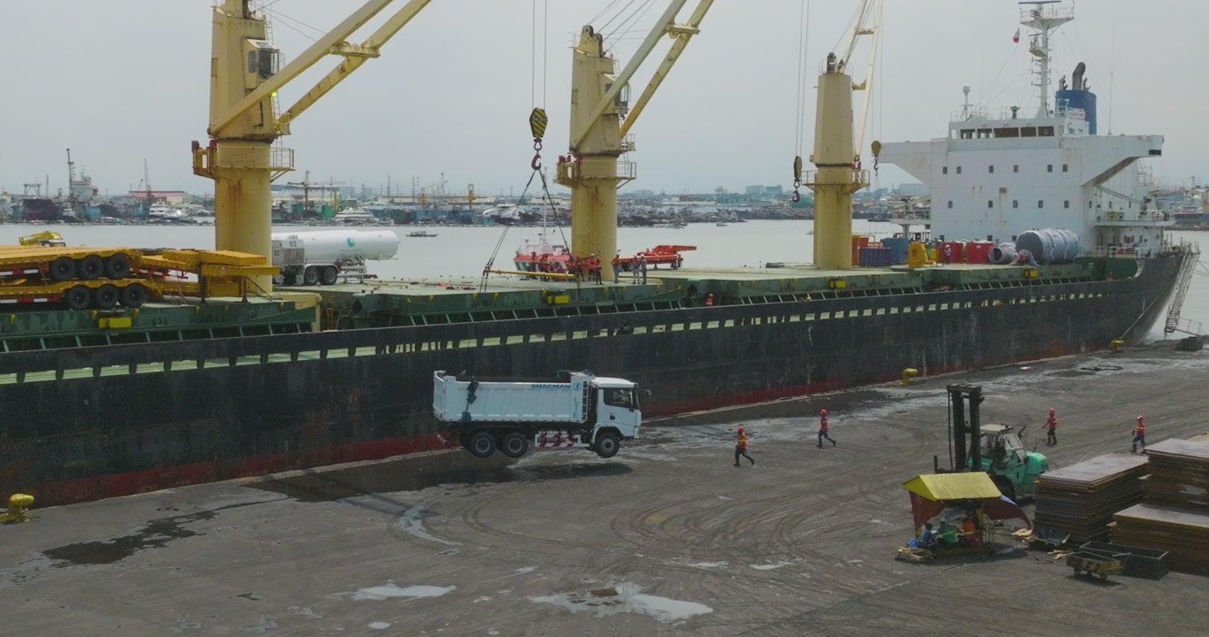 Workers Guiding Truck Lift at Harbor
