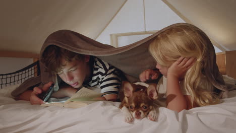 kids reading and relaxing with dog at night