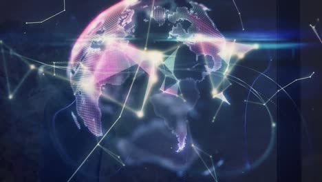 animation of globe and shapes over caucasian man using smartphone
