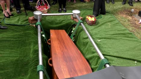 closeup shot of a funeral casket in a hearse or chapel or burial at cemetery