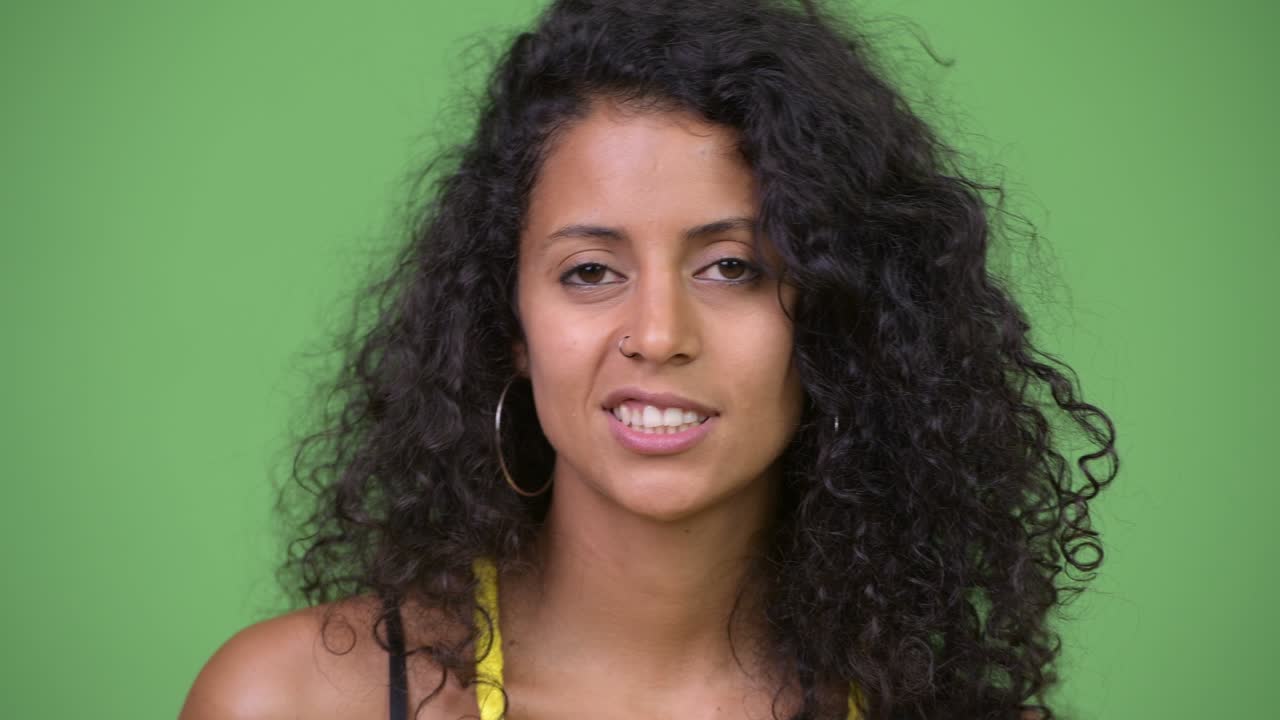 Young beautiful Hispanic woman looking bored