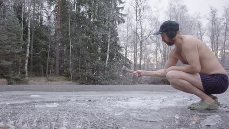 zoom in 240fps, a cool ice bather in boxers axing a lake to make a bathing hole