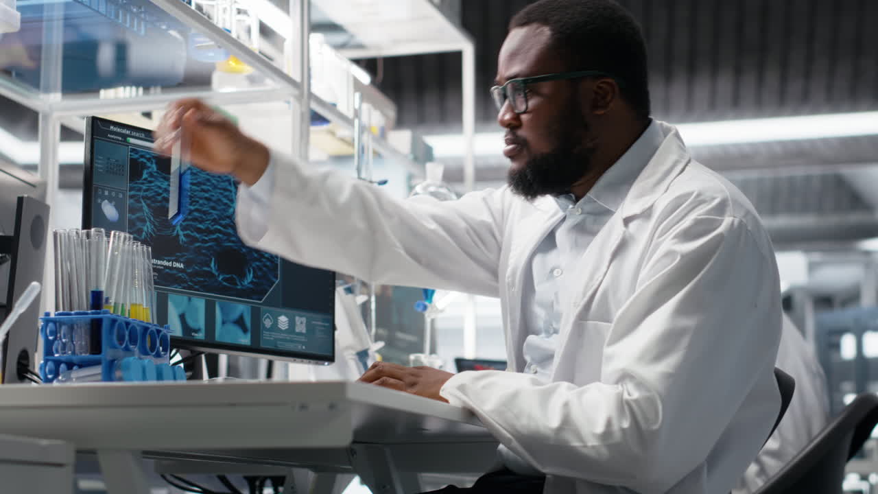 Vertical video Quality control analyst in laboratory analyzing solution at workstation using PC