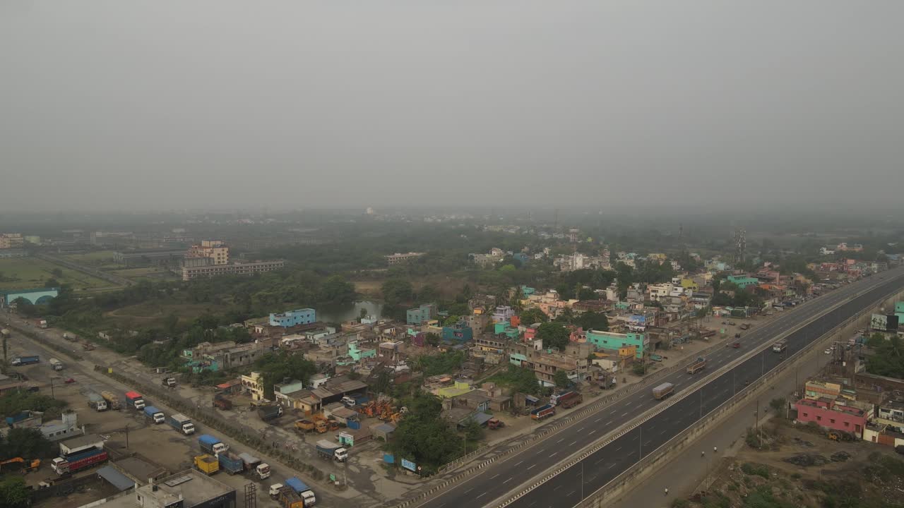 captura aérea de drones de fábricas en la india, centrándose en el denso humo que sale de sus chimeneas.