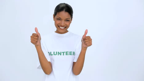 Smiling-volunteer-woman-does-a-thumbs-up-at-camera-