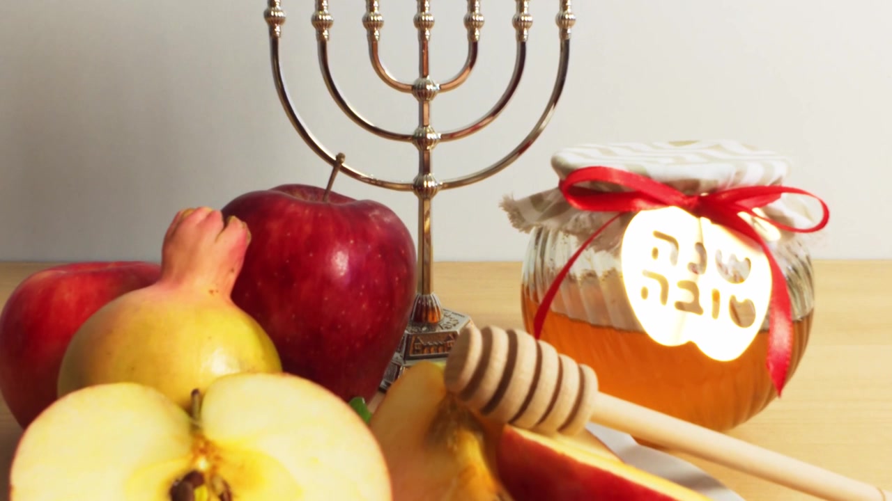 Rosh Hashanah Celebration Table with Apples, Honey, and Menorah