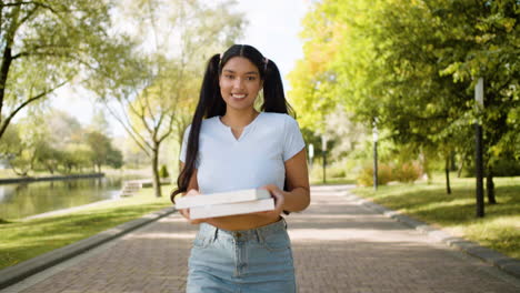 Smiling-woman-walking-at-park