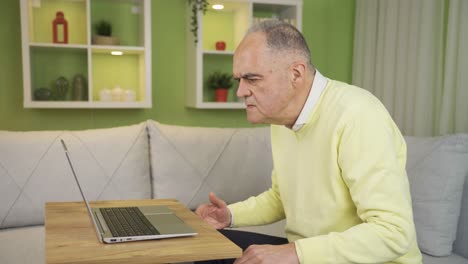 Old-man-working-on-laptop-is-surprised,-amazed-at-news-message.