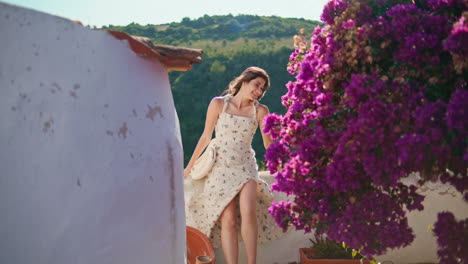 romantic woman posing sunshine balcony. happy girl looking camera at village