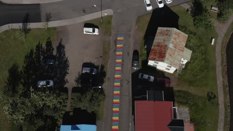 Above-Regnboga-Vegur-Rainbow-Road-with-Seyðisfjarðarkirkja-white-church