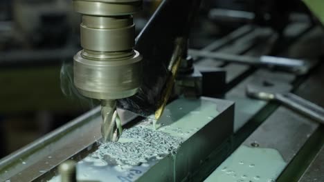 metal block milled by rotating tool with coolant in precision machine shop