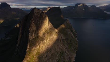 impressive rock cliff dropping into a fjord in norway