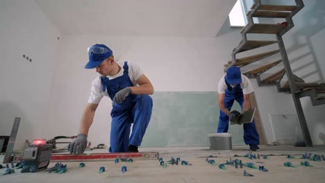 installing ceramic floor tiles - measuring and cutting the pieces. construction, renovation, repair apartment. cuts tile. tile cutting