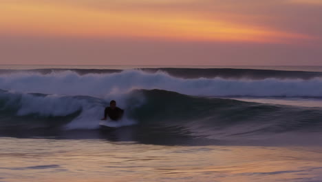 surfer riding a wave at sunset