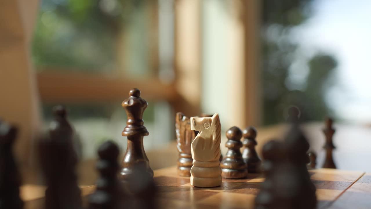Close-up of chess move, queen takes horse, strategic game moment