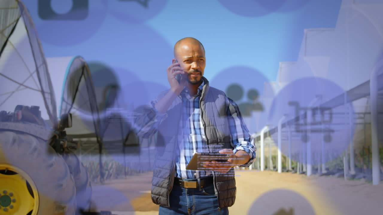 Digital icons moving against man talking on a smartphone