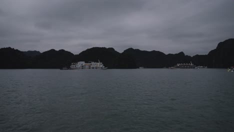 nighttime shot of a cruise ship anchored in ha long bay, vietnam