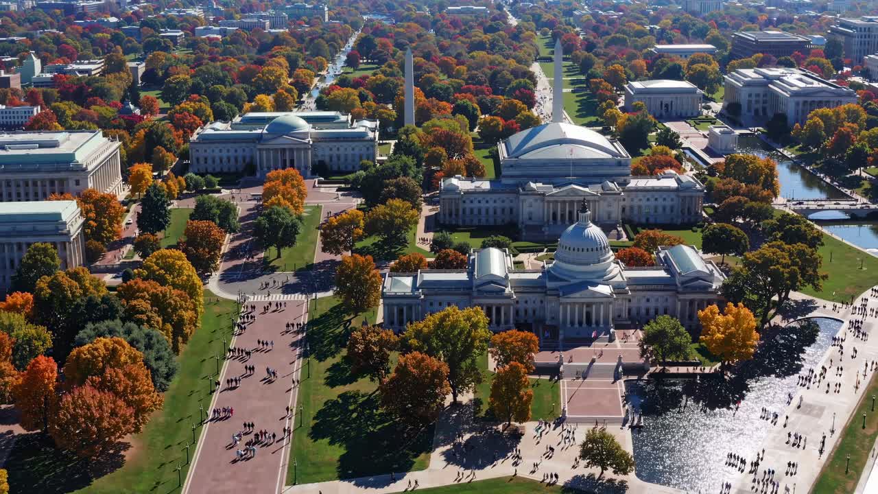 Aerial view of a cityscape with historic buildings and autumn trees, capturing vibrant colors