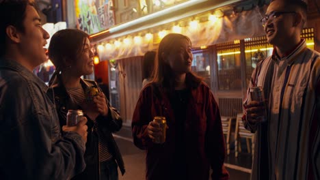 friends enjoying drinks in a night market