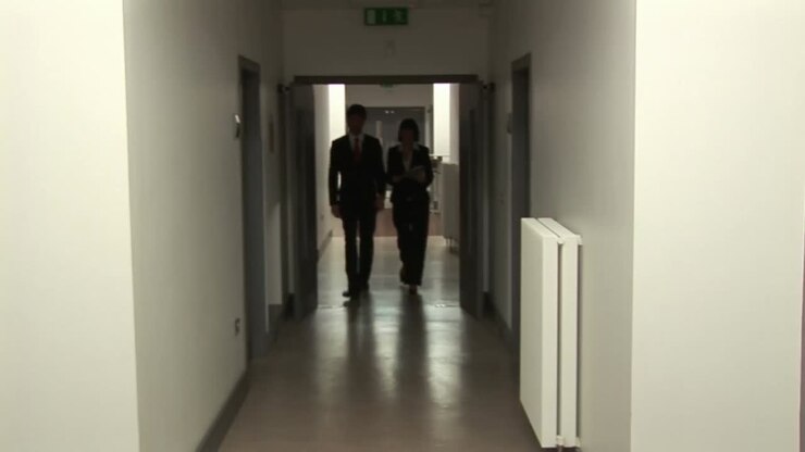 Business People Walking in Corridor