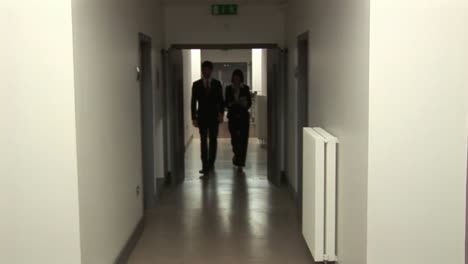 business people walking in corridor