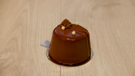 cute dark chocholate mini cake isolated slowly rotating